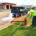 Water Department Staff member flushing hydrant